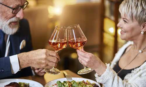 enjoy life again couple toasting while eating steak